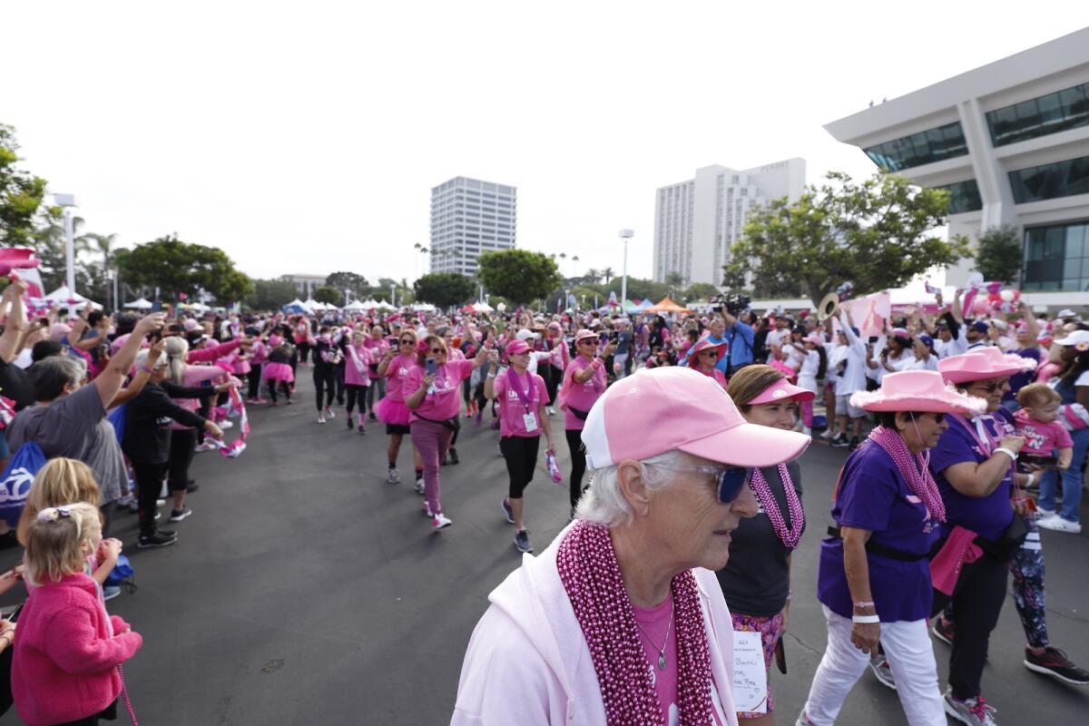 Wearing pink, breast cancer survivors and supporters at Fashion Island.