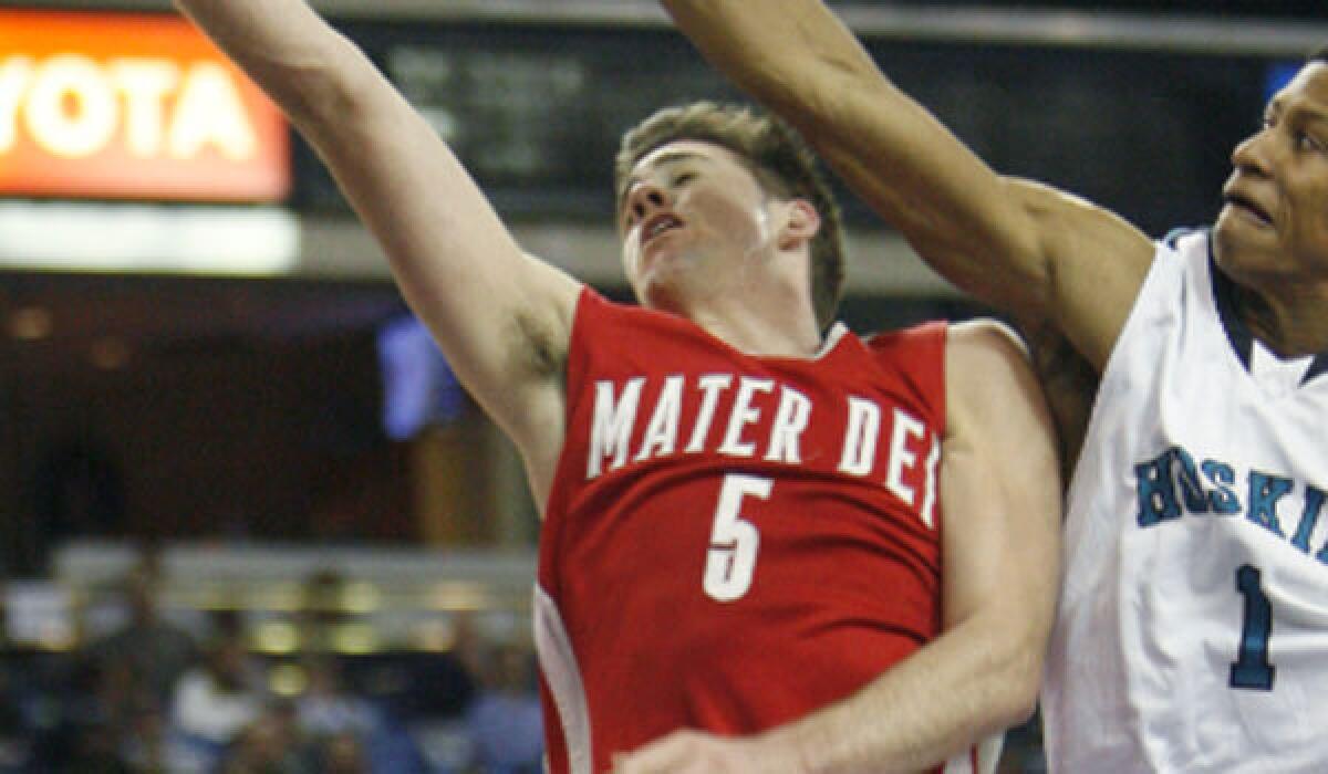 Katin Reinhardt, left, takes a shot for Mater Dei in 2012.