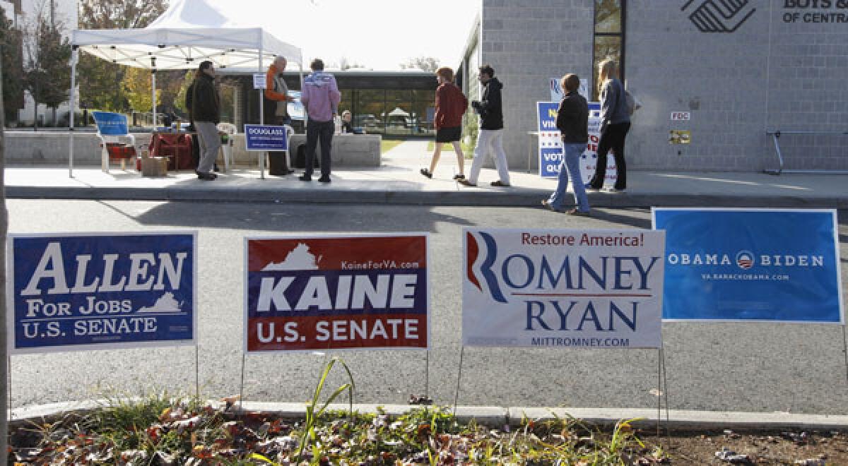 Republican and Democratic signs line the way for voters as they make their way into the Boys and Girls Club to cast their votes Tuesday on Election Day in Charlottesville, Va.