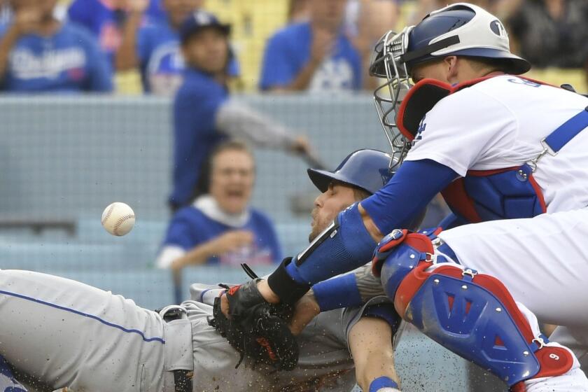 New York Mets second baseman Jeff McNeil is safe at home as Los Angeles Dodgers' Yasmani Grandal loses the ball during the fourth inning of a baseball game Wednesday, Sept. 5, 2018, in Los Angeles. (AP Photo/John McCoy)