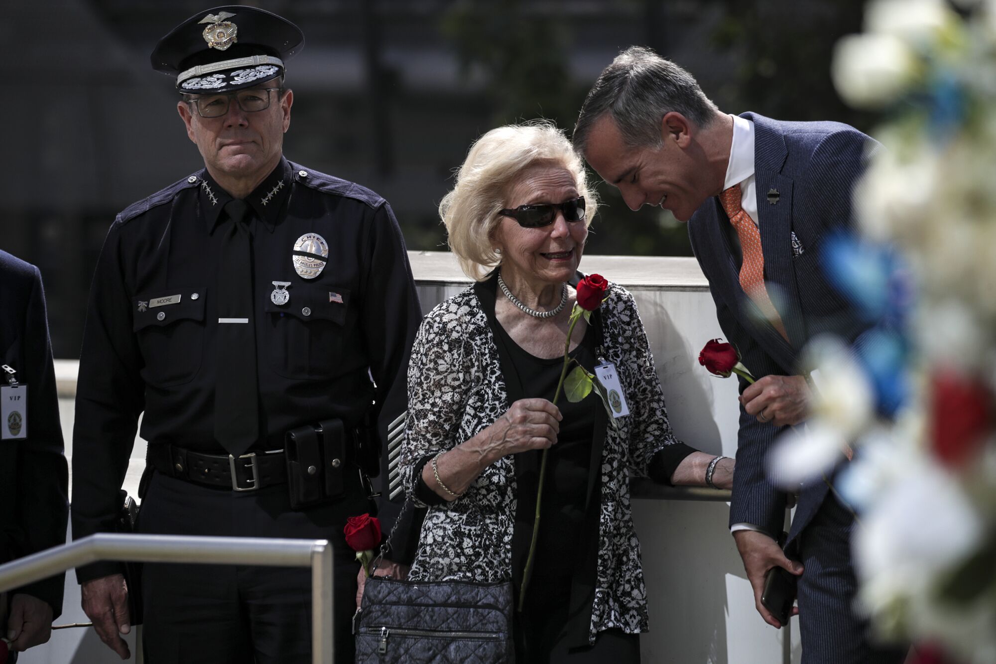 Los Angeles Police Chief Michel Moore, left, Flo Speck and Mayor Eric Garcetti at a memorial ceremony.
