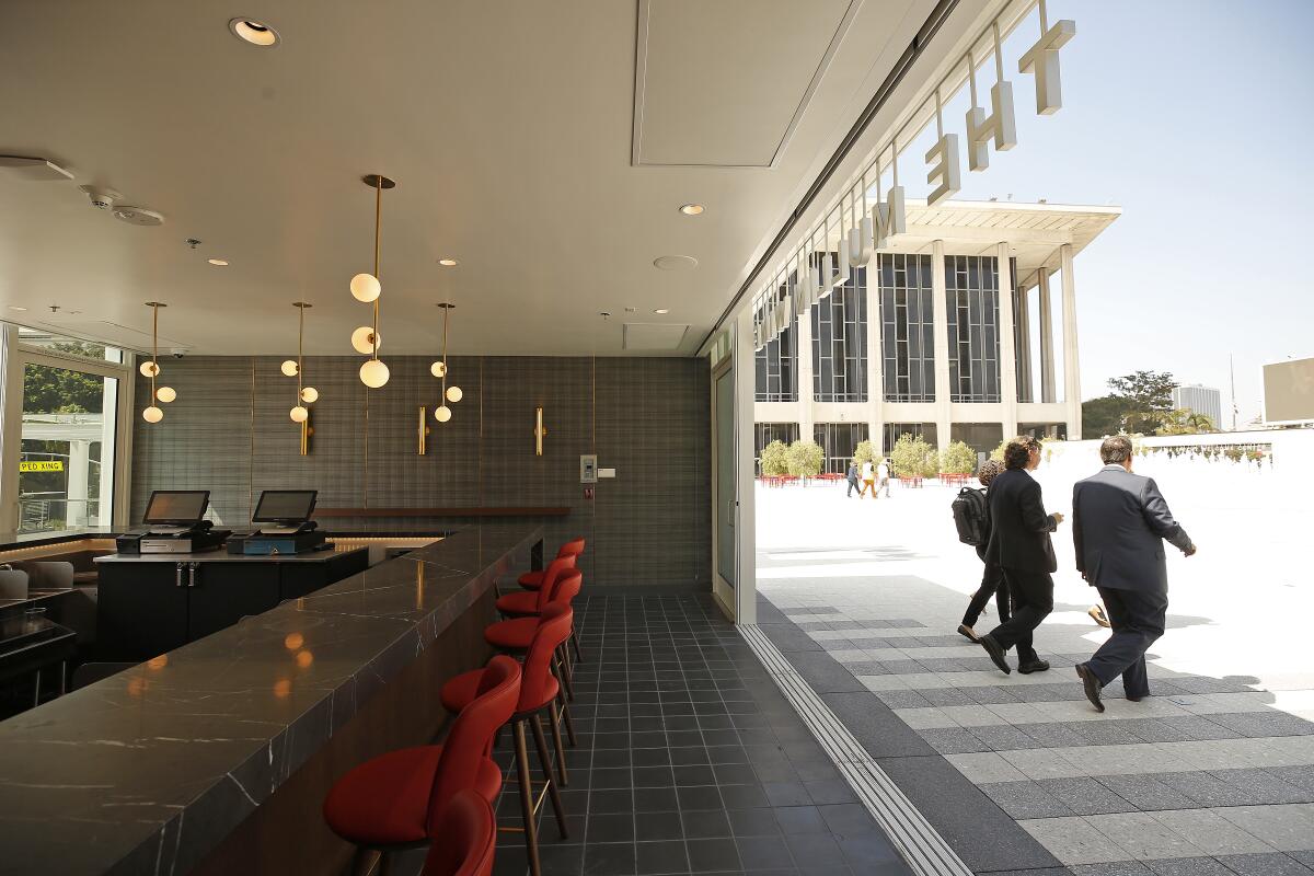 Wine bar counter and stools, in a space that opens to the Music Center plaza with the Chandler Pavilion in the background