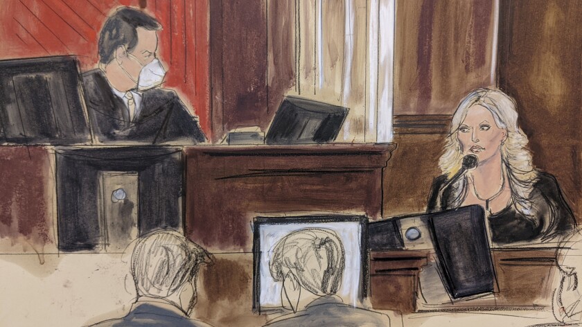 This courtroom sketch shows presiding Judge Jesse Furman, left, listening as Stormy Daniels testifies in her lawsuit trial against Michael Avenatti in federal court, Friday Jan. 28, 2022, in New York. (Elizabeth Williams via AP)
