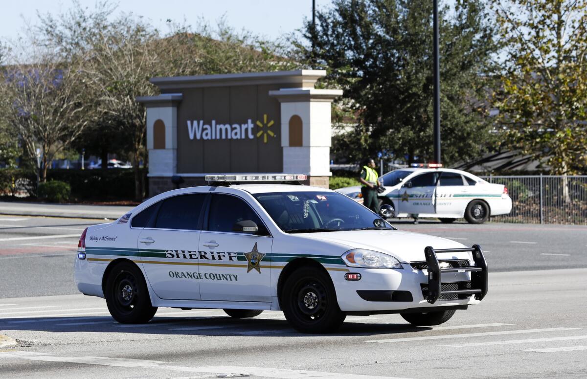 Police block the entrance to a Wal-Mart near where an Orlando, Fla., police officer was shot Monday.
