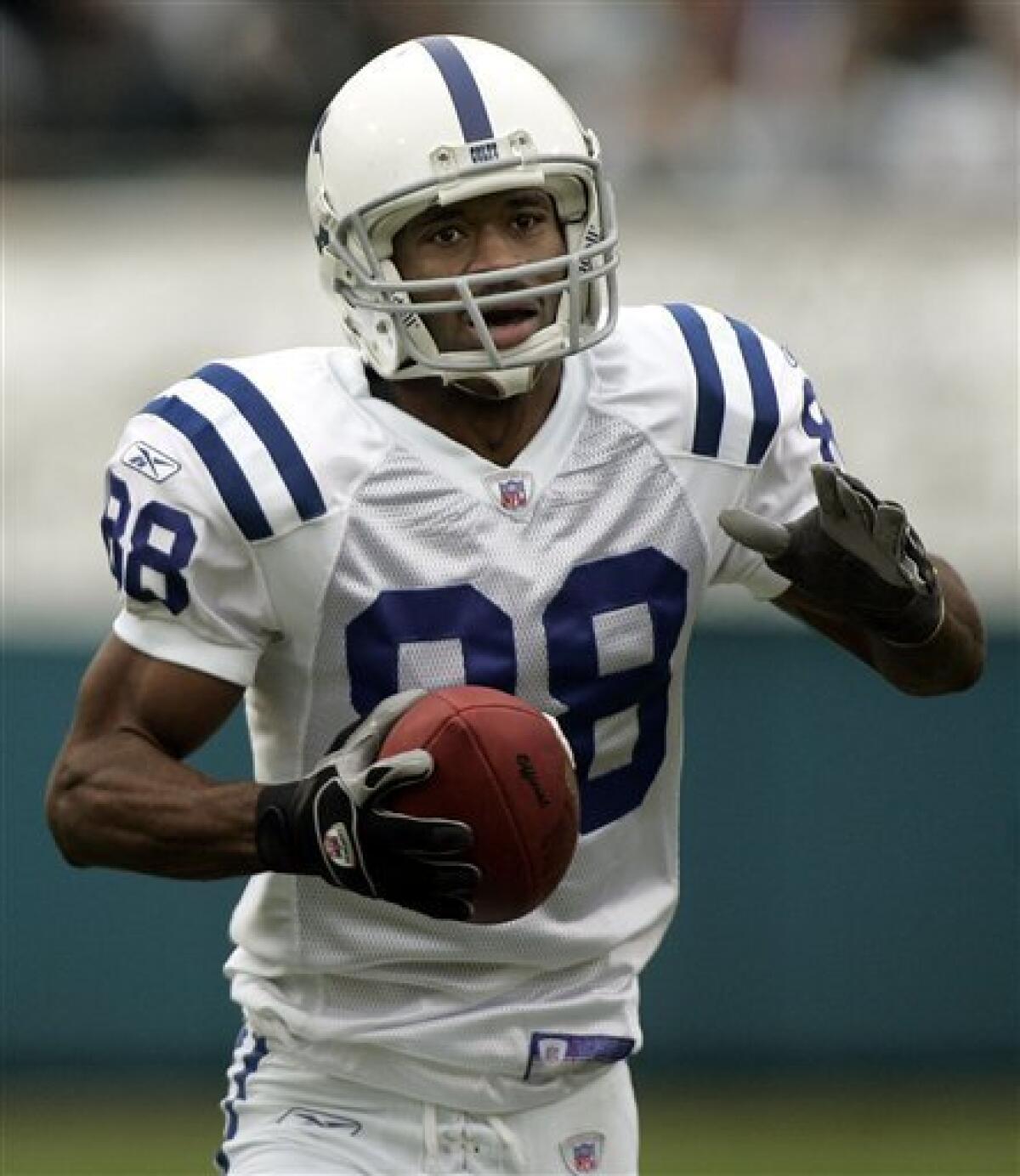 In this Dec. 11, 2005, file photo, Indianapolis Colts receiver Marvin Harrison scores a touchdown against the Jacksonville Jaguars in an NFL football game in Jacksonville, Fla. Harrison's reluctance to take a pay cut could mark the end of his career in Indianapolis. (AP Photo/Phil Coale, File)