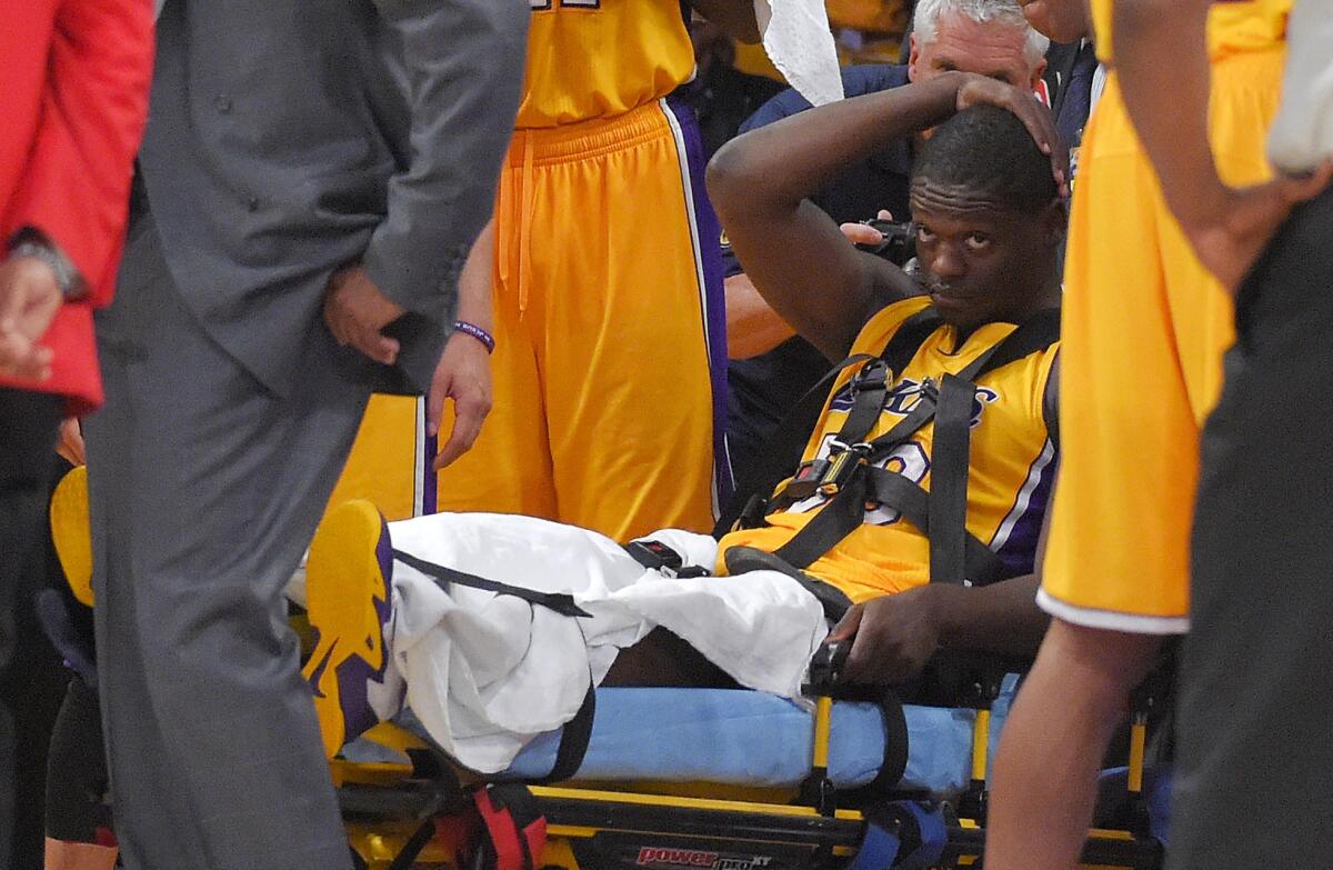 Lakers rookie Julius Randle sits on a stretcher after suffering a season-ending injury at Staples Center on Oct. 28.