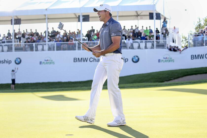 Jason Day celebrates on the 18th green after sinking his last putt for birdie, winning the BMW Championship.