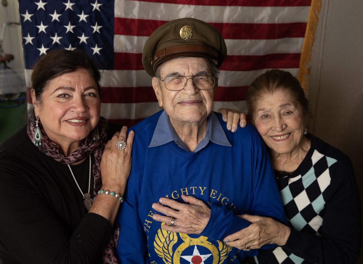 latest news A veteran killed in France during the Second World War turns 100 3 An older man in a military hat holds his hand to his chest as two women flanking him in front of an American flag.