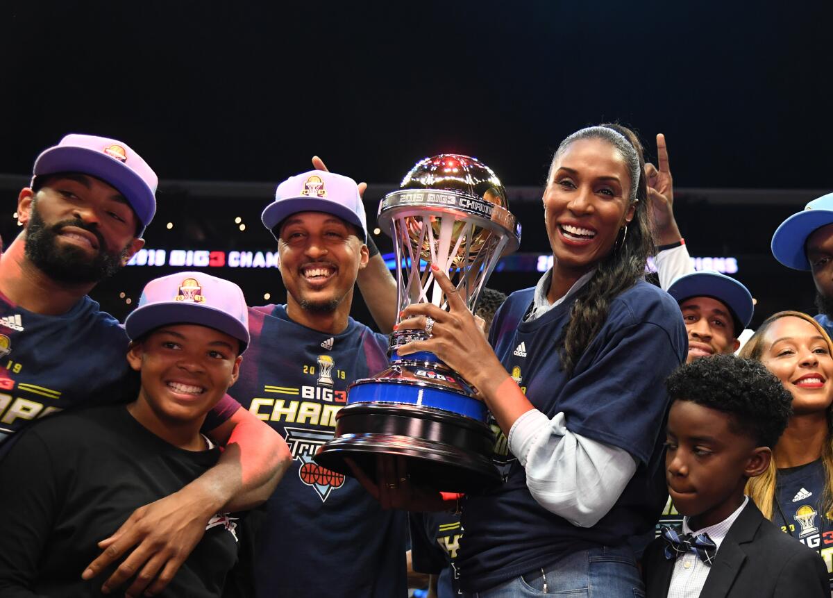 Triplets head coach Lisa Leslie, Jamario Moon celebrate with the trophy after defeating the Killer 3s to win the BIG3 Championship at Staples Center on Sunday.