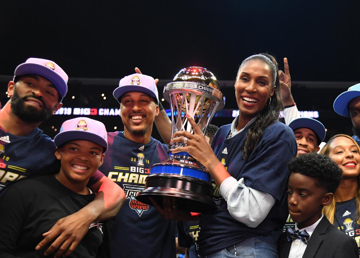 Lisa Leslie hoists the BIG3 championship trophy with the team she coached, The Triplets, on Sept. 1, 2019, at Staples Center.