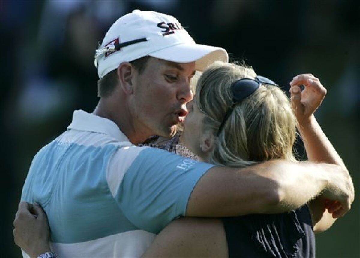 Henrik Stenson, of Sweden, kisses his wife, Emma, after winning The Players Championship golf tournament at TPC Sawgrass in Ponte Vedra Beach, Fla., Sunday, May 10, 2009. (AP Photo/Phil Coale)
