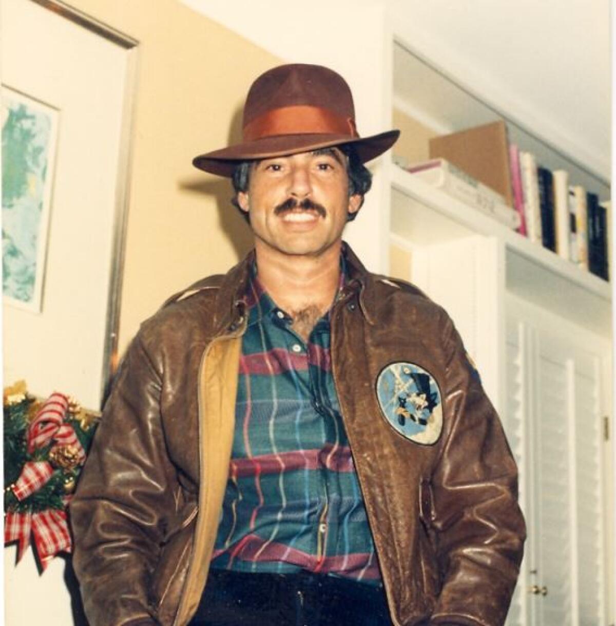 A man in a hat and leather jacket