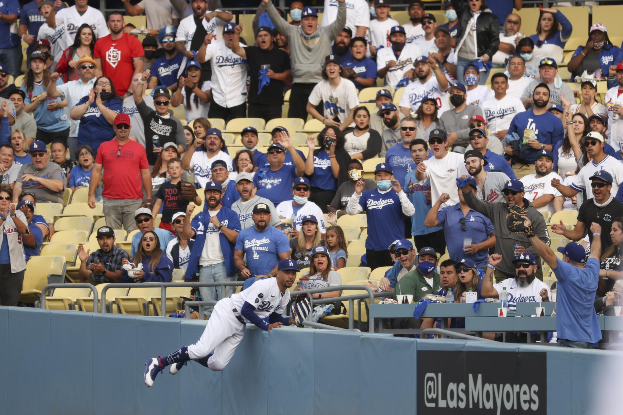 The crowd cheers after Los Angeles Dodgers right fielder Mookie Betts makes a catch at the right field wall