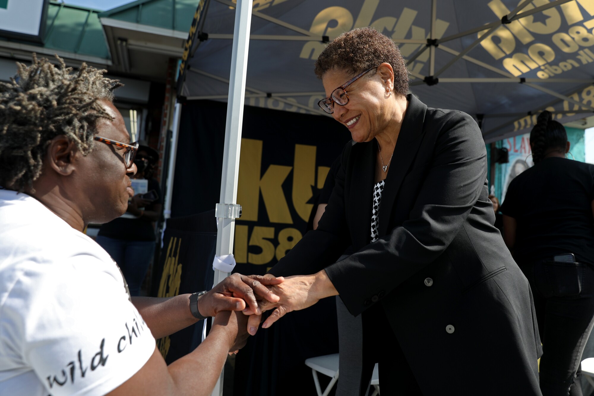 Rep. Karen Bass, right, mayoral candidate for Los Angeles, greets a man.