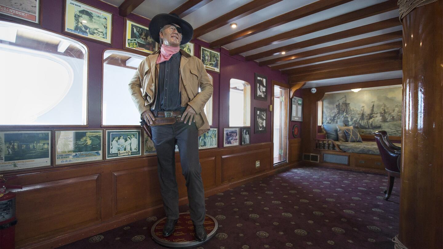 A life-size wax figure of John Wayne stands inside the late actor's yacht, the Wild Goose, in Newport Beach on Tuesday. Hornblower is bringing back its John Wayne cruises Thursday through June 18 to celebrate the Duke's 110th birthday.