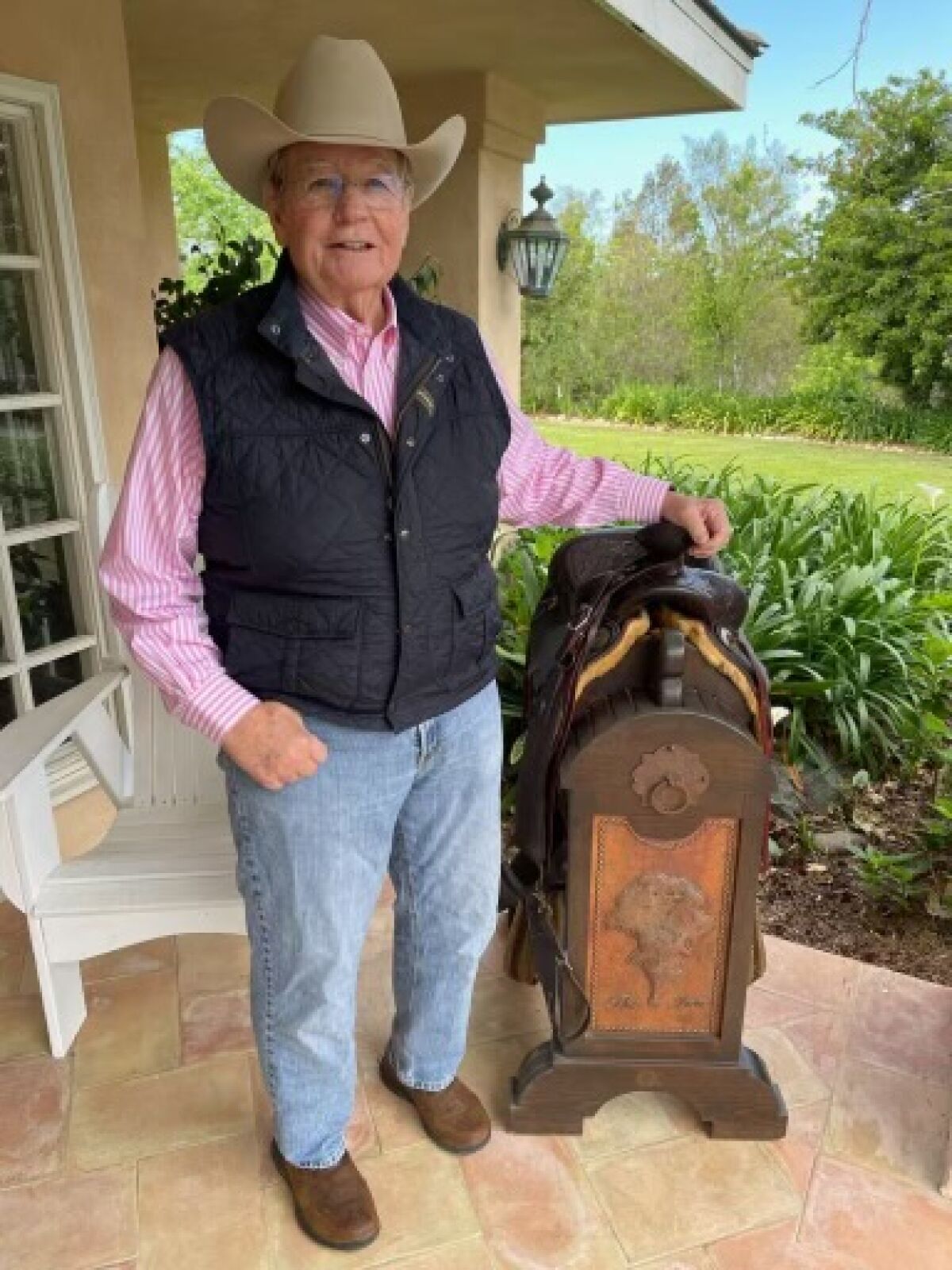 Buck Bennett with his saddle and stand from The Inn at Rancho Santa Fe.