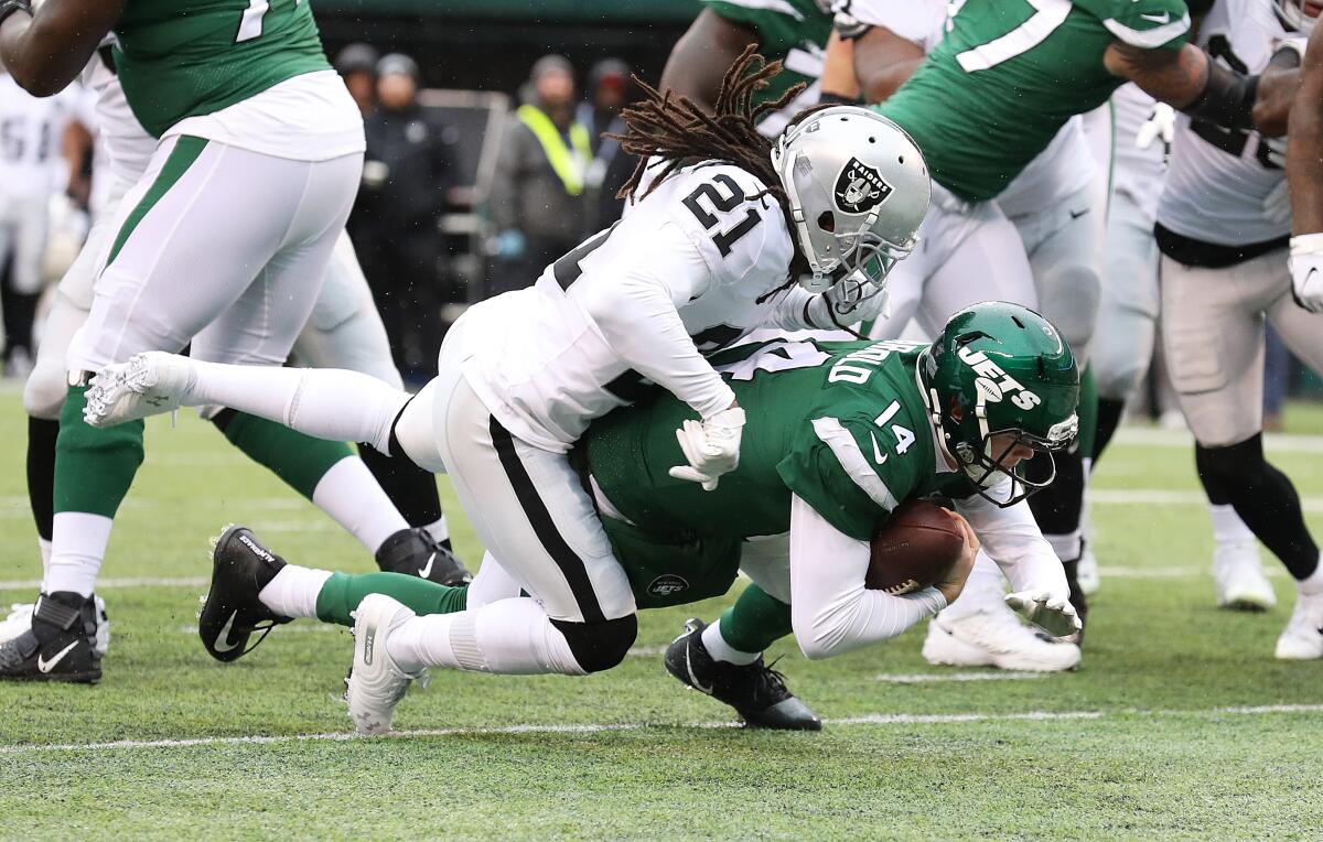 Jets quarterback Sam Darnold gets past Raiders defensive back D.J. Swearinger to score a touchdown during their game Nov. 24, 2019, in East Rutherford, N.J..