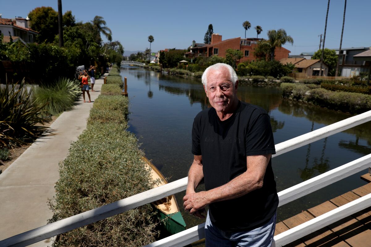 Stephen Yagman stands on a bridge in front of a canal
