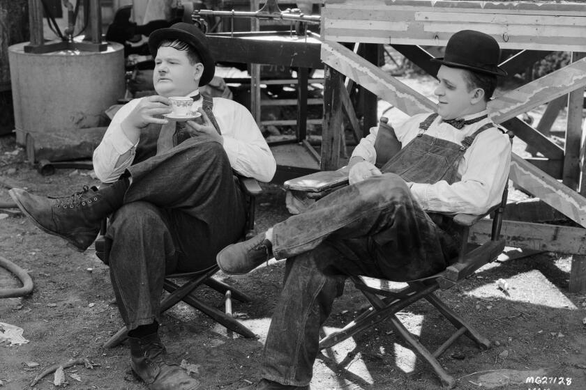 Oliver Hardy, left, and Stan Laurel during a break in the filming of "Towed in a Hole."