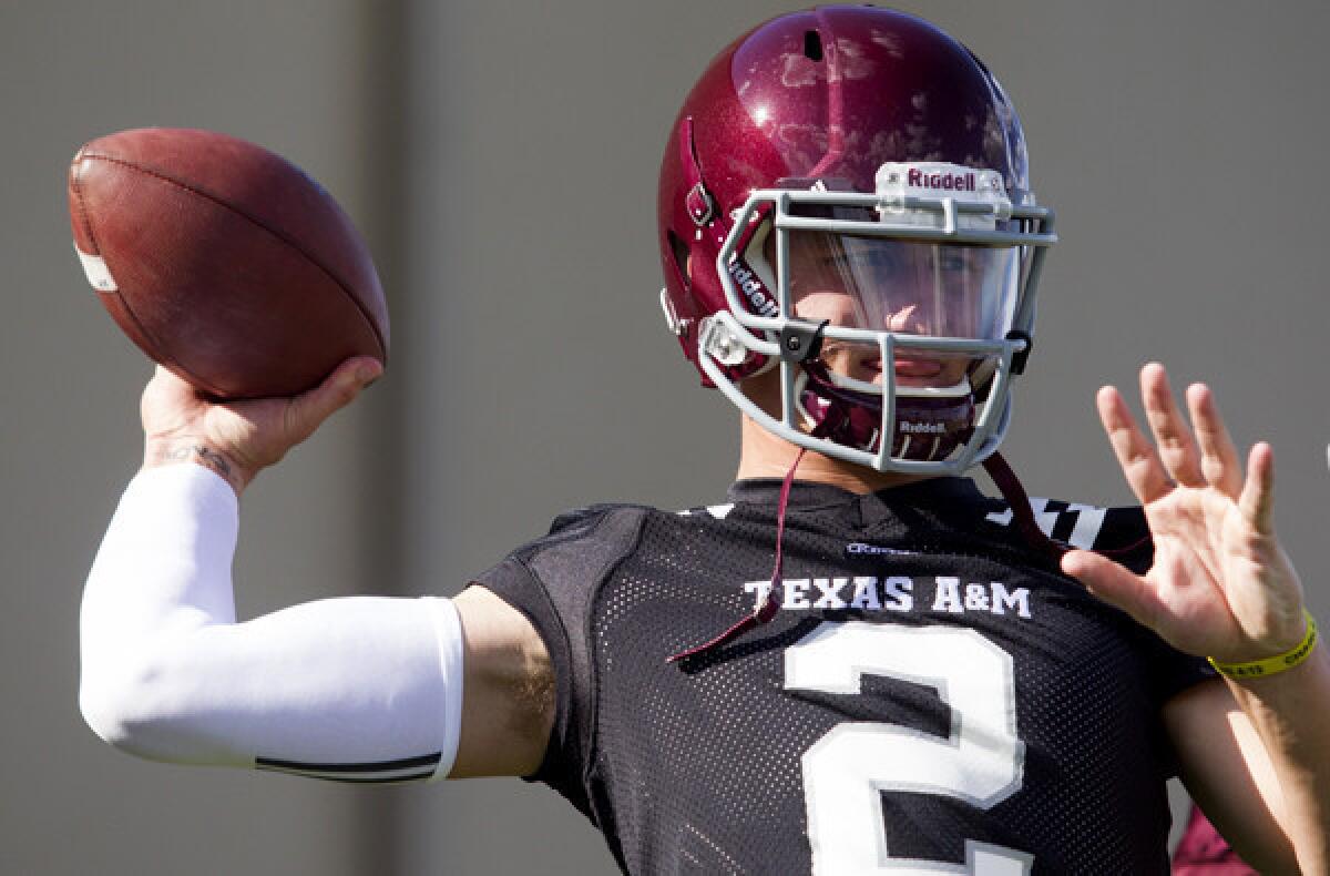 Texas A&M; quarterback Johnny Manziel loosens up during practice on Monday.