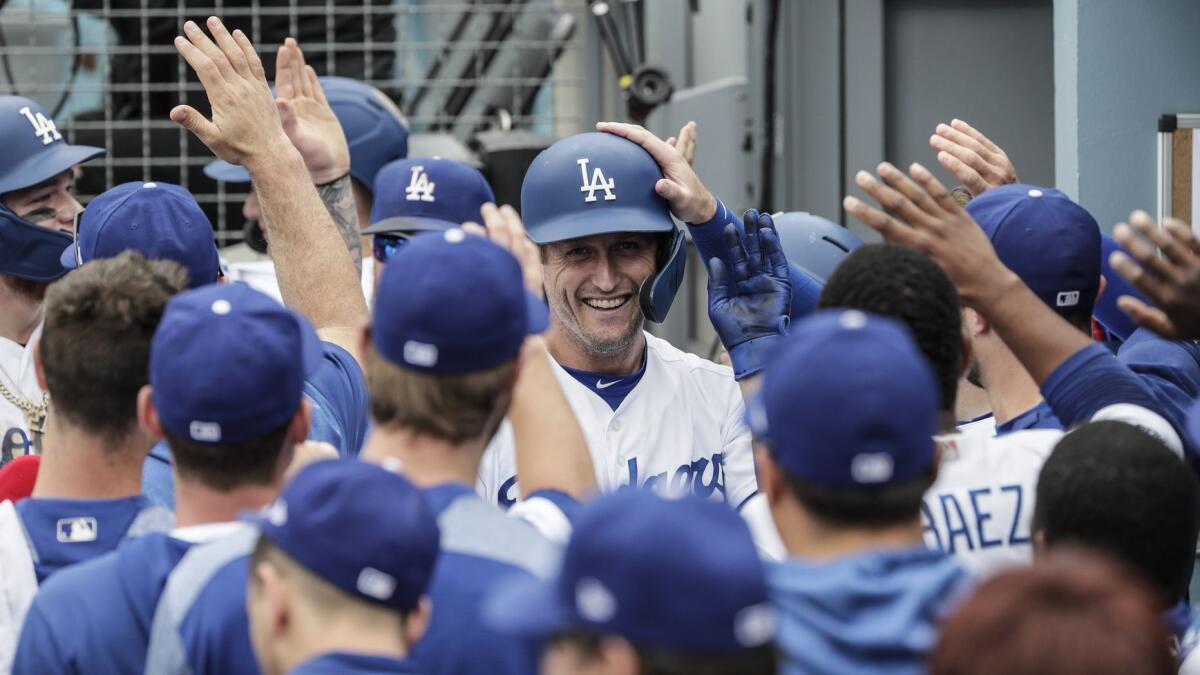 Dodgers first baseman David Freese celebrates in the dugout after scoring in the eighth inning of an 8-0 victory over the Philadelphia Phillies on June 2.