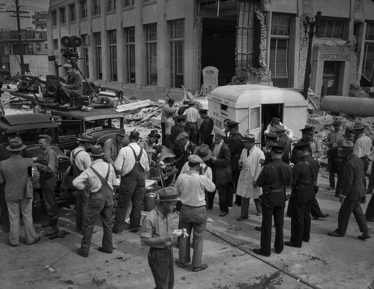March 13, 1933: Hungry people are fed in Compton after the Long Beach earthquake. On the left is a news camera vehicle with "Pathe News" sign in front window.