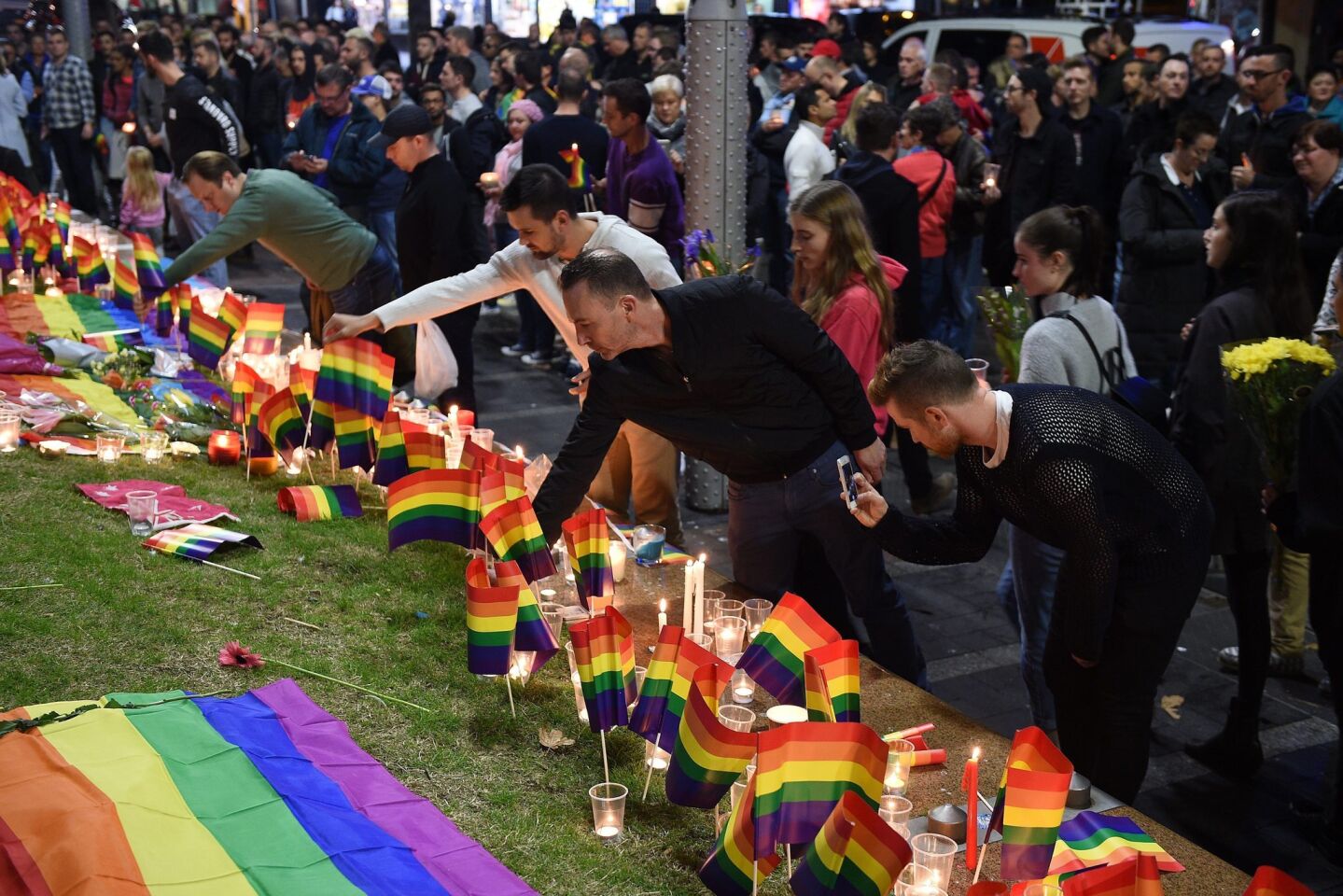 People gather at Taylor Square in Sydney, Australia, to show solidarity with victims of the Orlando nightclub shooting.