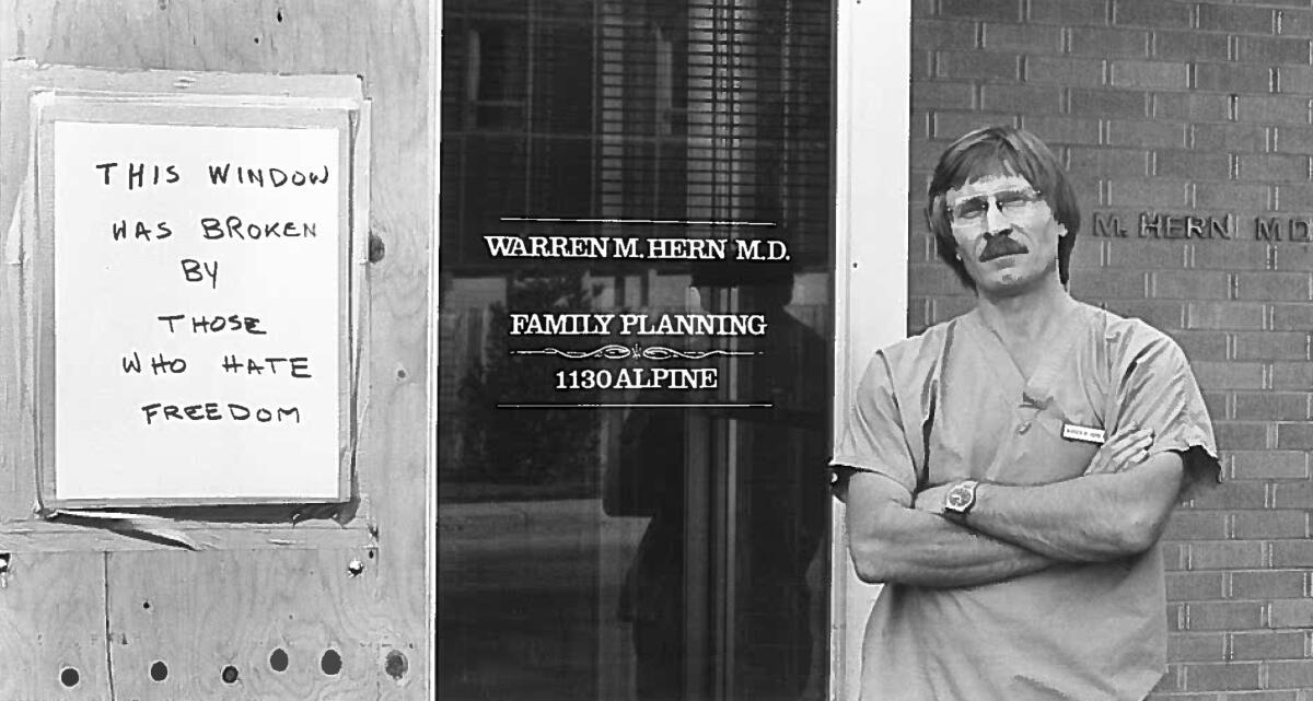 Dr. Warren Herd stands outside his office that says "family planning" on the door