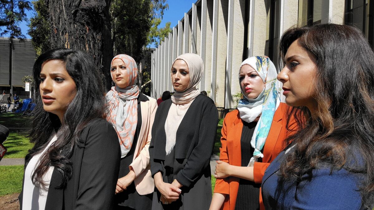 Sara Farsakh, 29, left, stands with three other plaintiffs and one of their lawyers. The women are suing Urth Caffe in Laguna Beach for discrimination, alleging they were targeted in April for being "visibly Muslim."