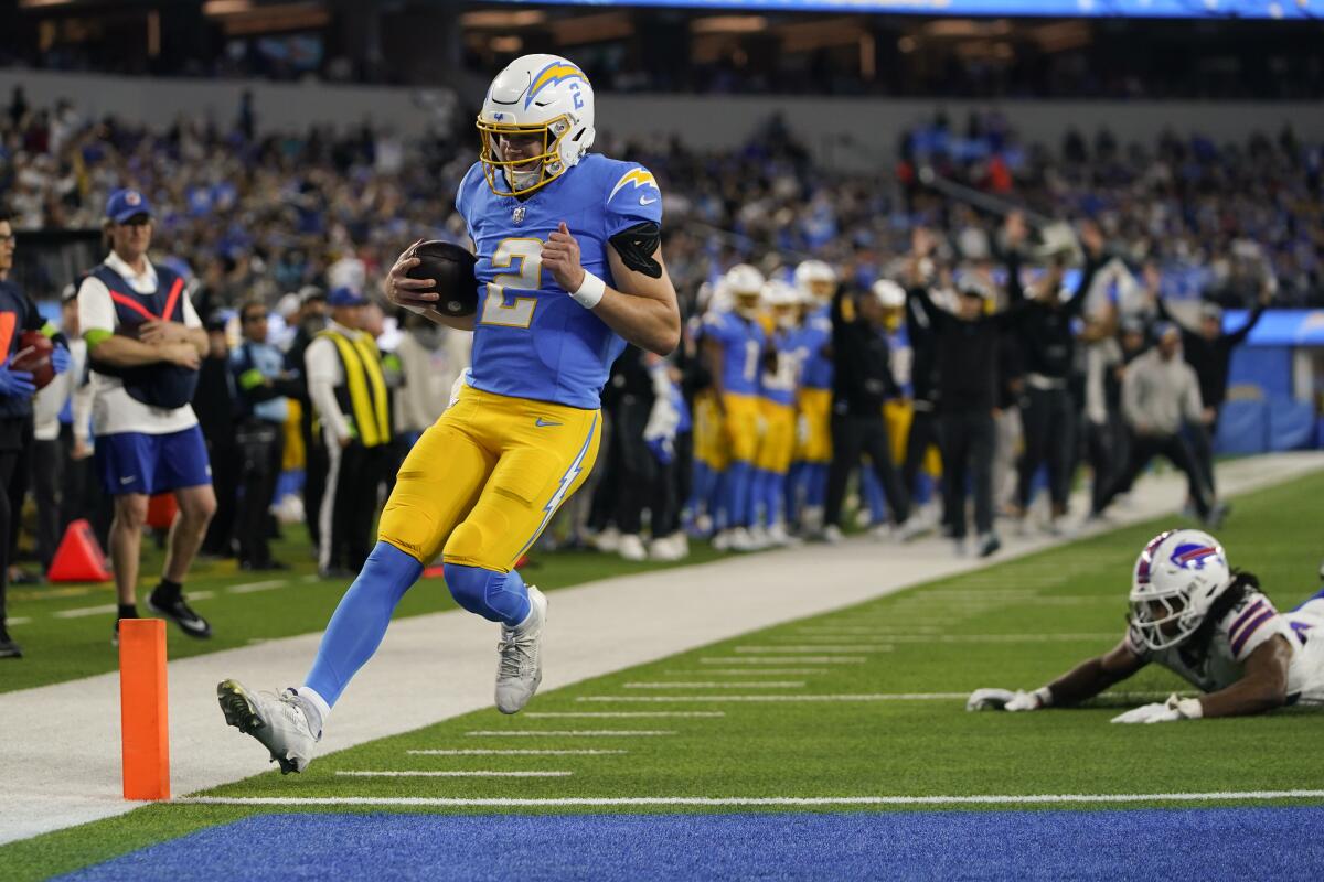 Chargers quarterback Easton Stick scores on a touchdown run in the first half against the Bills.