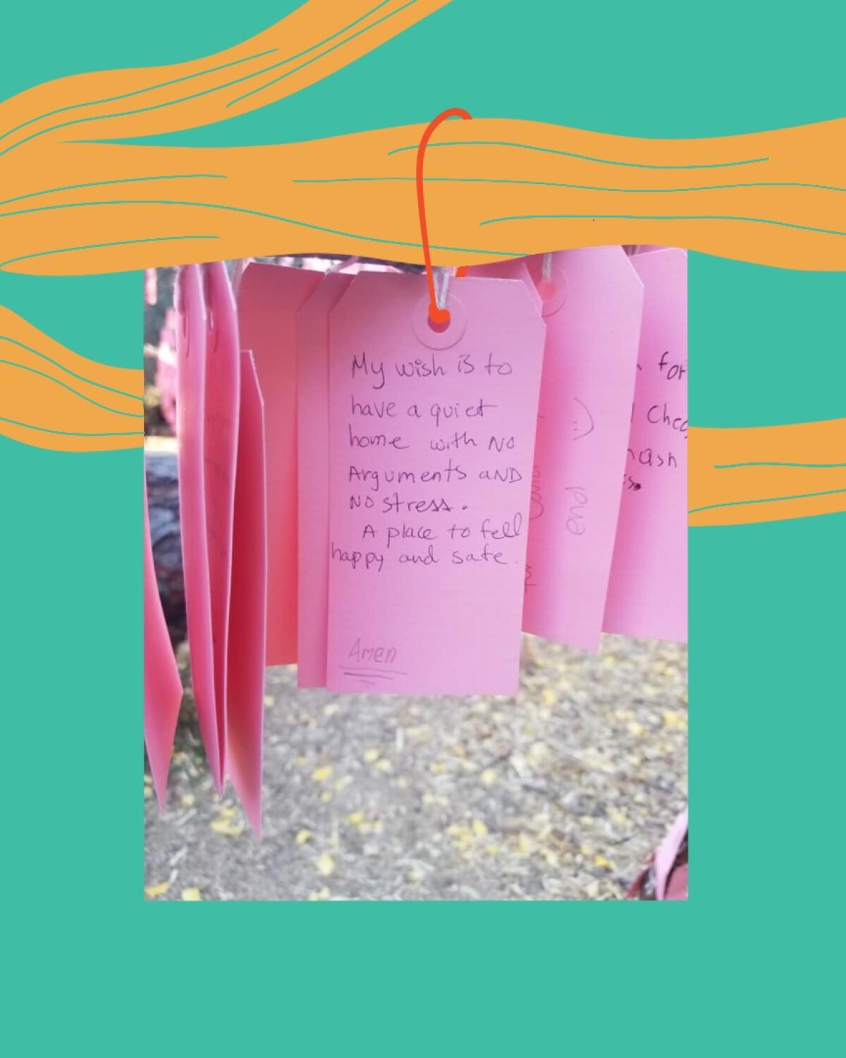 Wishes handwritten on pink cards hang on a tree.
