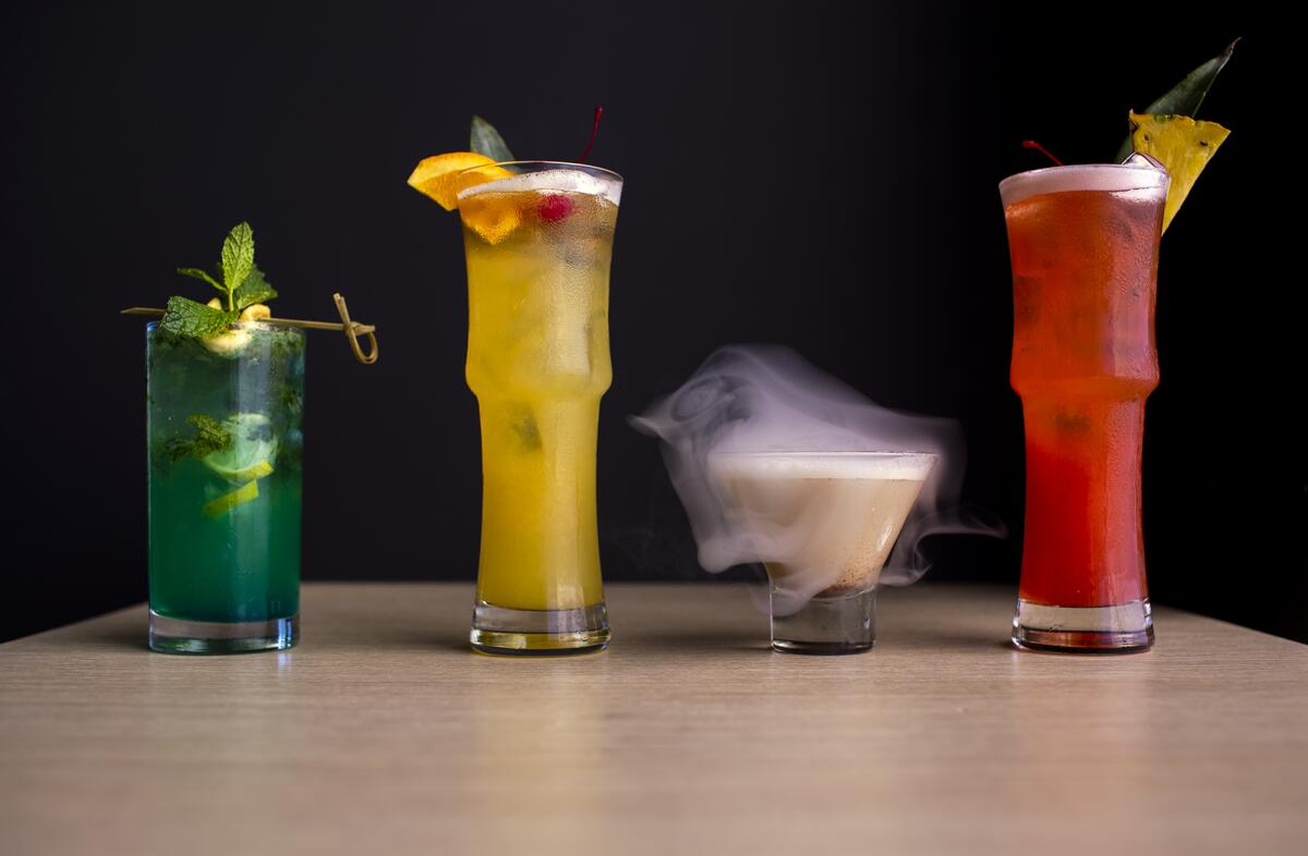 The Blue Apple Mojito, left, the Mai Thai Not Yours, the Butterscotch Smoke Bubble and the Singapore Sling.