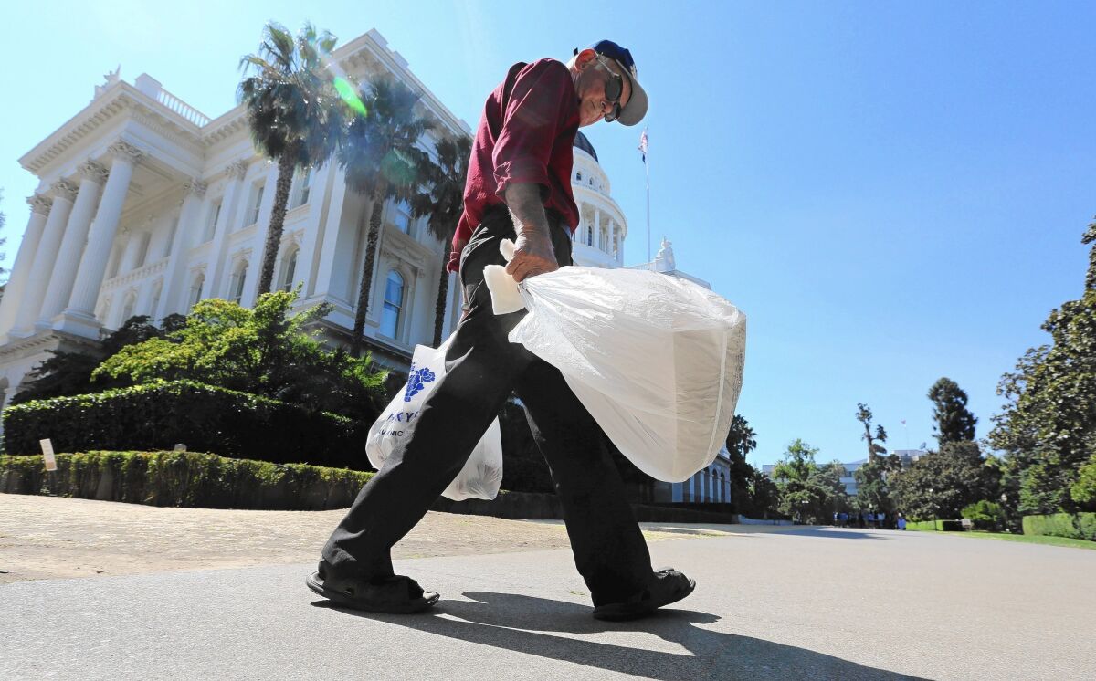 Under a bill signed into law by Gov. Jerry Brown, grocery stores and pharmacies must stop dispensing single-use plastic bags beginning July 1. The ban will be extended to convenience and liquor stores in July 2016.