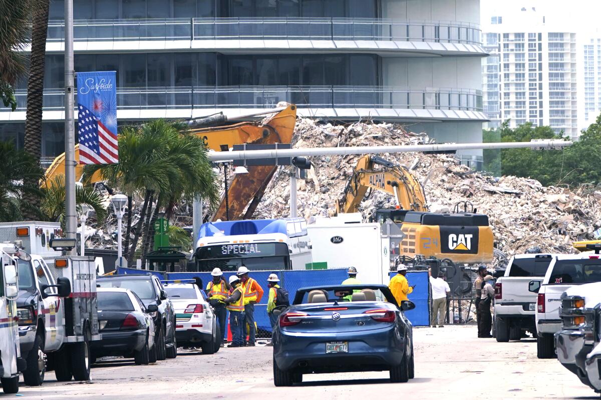 Crews work in the rubble of the Champlain Towers South building, as removal and recovery work continues at the site of the partially collapsed condo building, Tuesday, July 13, 2021, in Surfside, Fla. (AP Photo/Lynne Sladky)