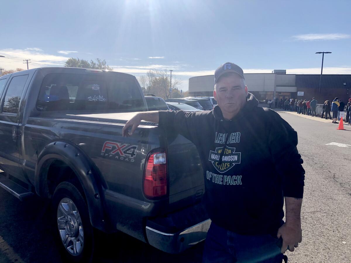 Jay Downen leans against his truck at a Michigan polling place.