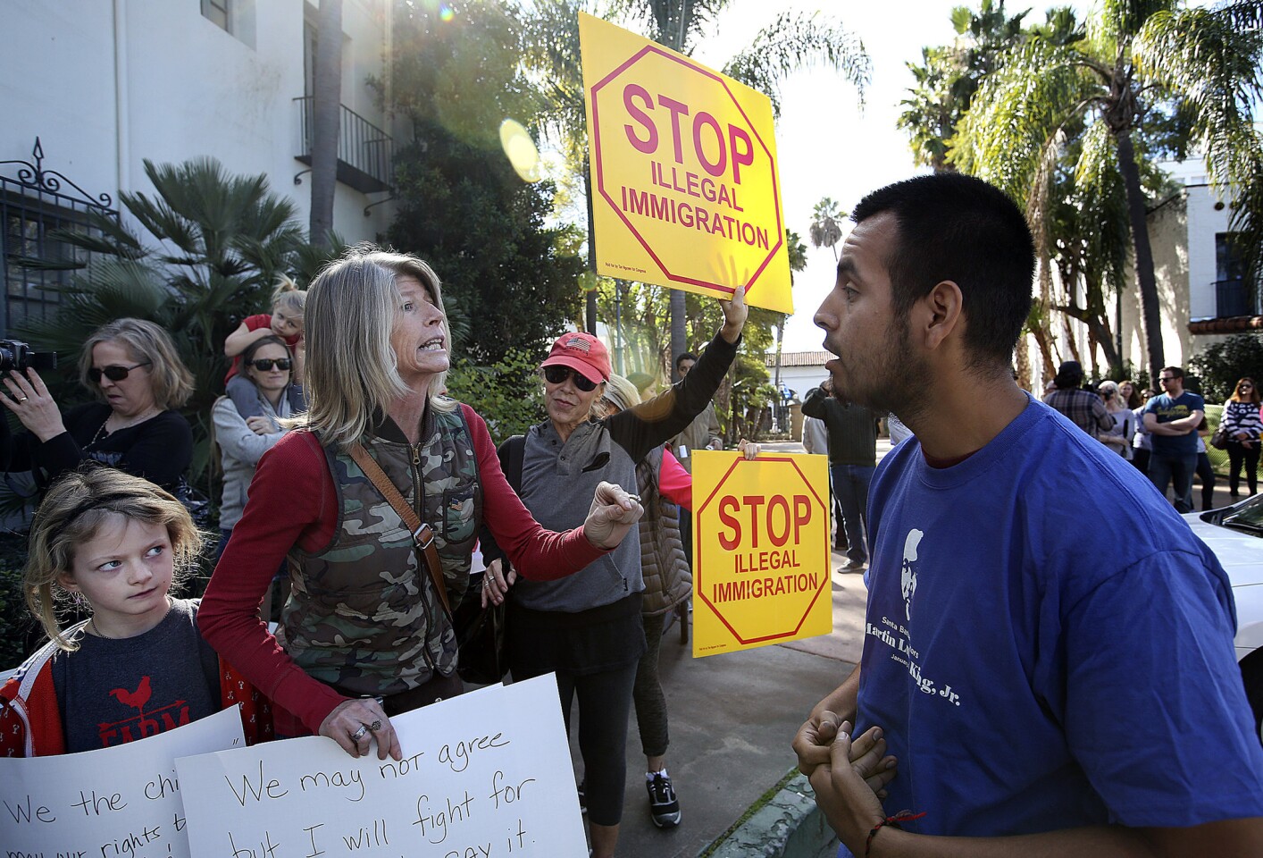 Mona Hansen, who supports the Santa Barbara News-Press, argues with Julio Ricon.