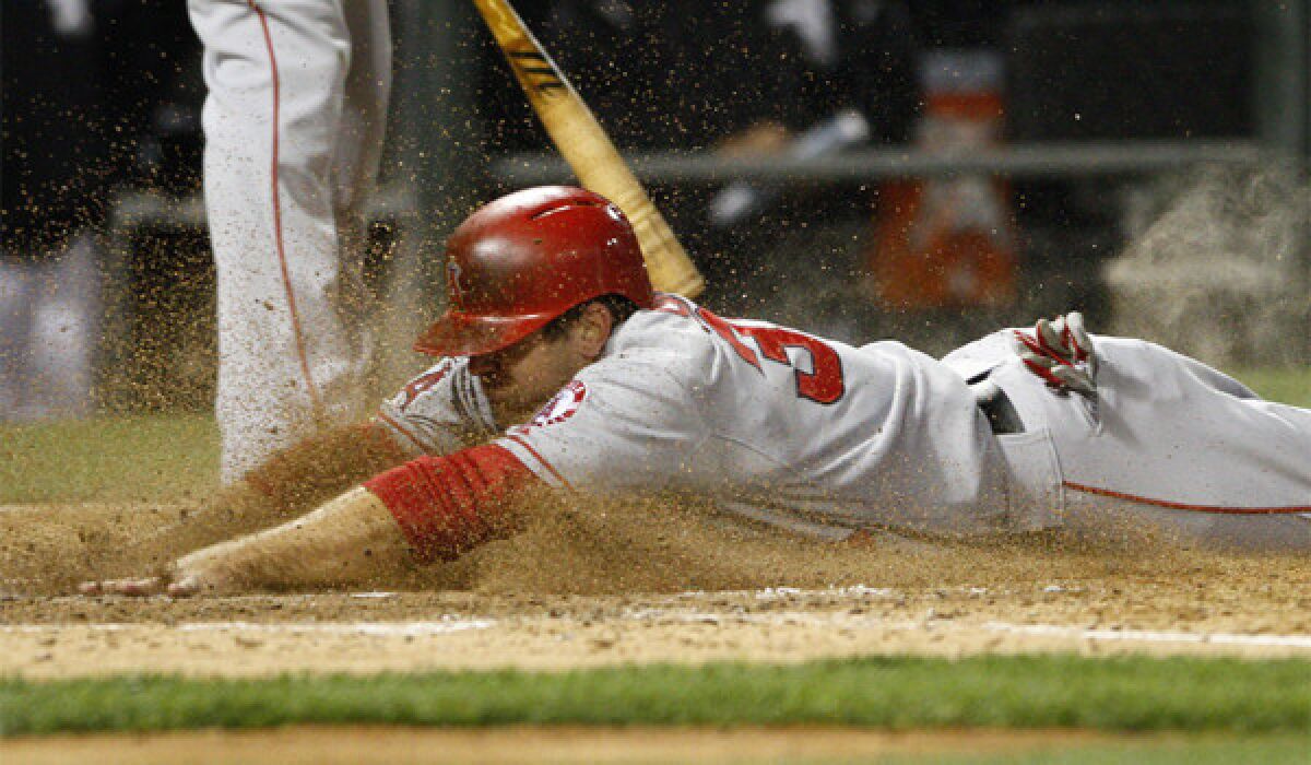 Outfielder J.B. Shuck dives across home plate Friday night while playing in his 10th straight game for the injury-depleted Angels.