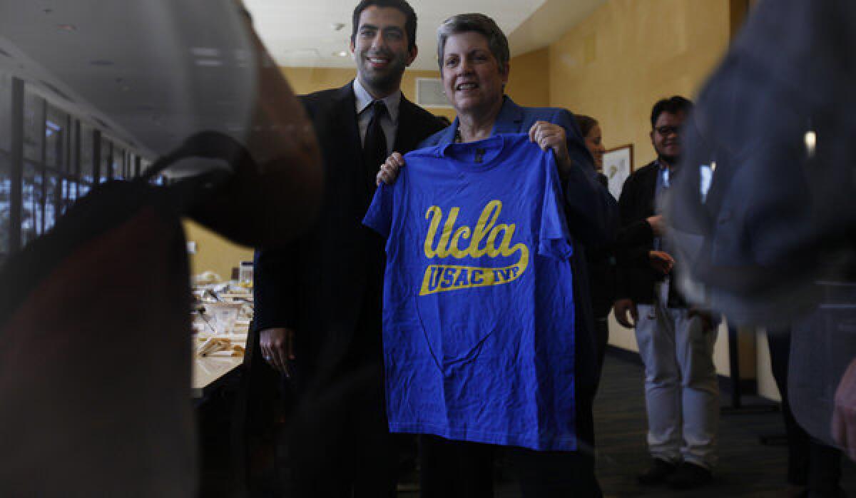 Internal Vice President of the Undergraduate Student Assn. Council Avi Oved, left, presents a UCLA T-shirt to University of California's President Janet Napolitano on Friday.