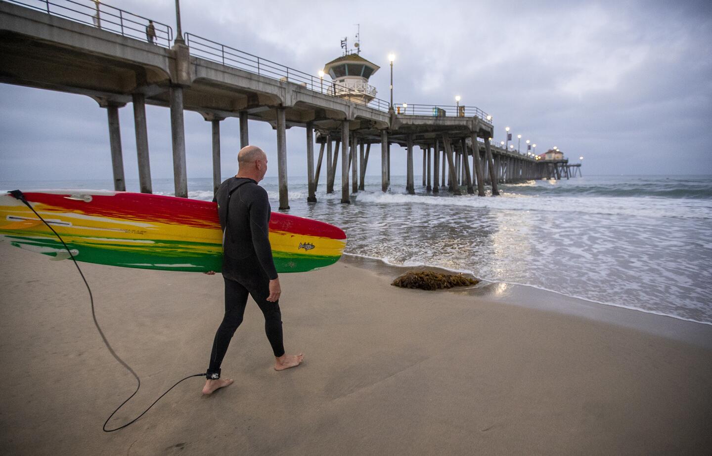 Tom Thrasher hits the waves Thursday morning as surfers in Huntington Beach celebrated the inaugural California Surfing Day.