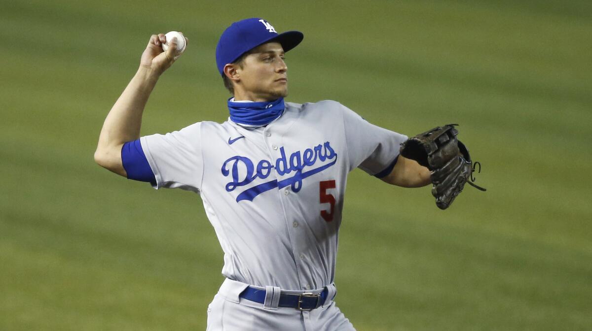 Los Angeles Dodgers shortstop Corey Seager throws to first base as he warms up.