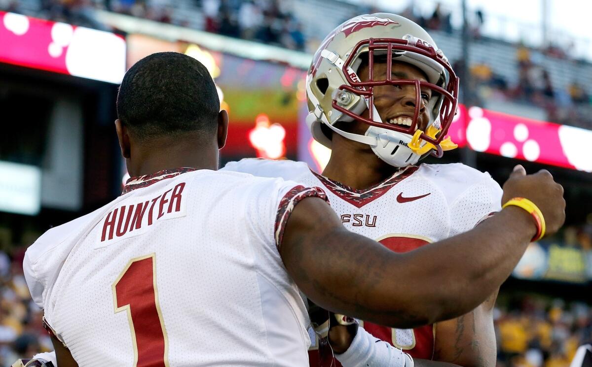 Florida State's P.J. Williams, right, celebrates an interception with teammate Tyler Hunter during a win over Boston College last month. The Seminoles are helping the ACC regain some clout in the college football world.