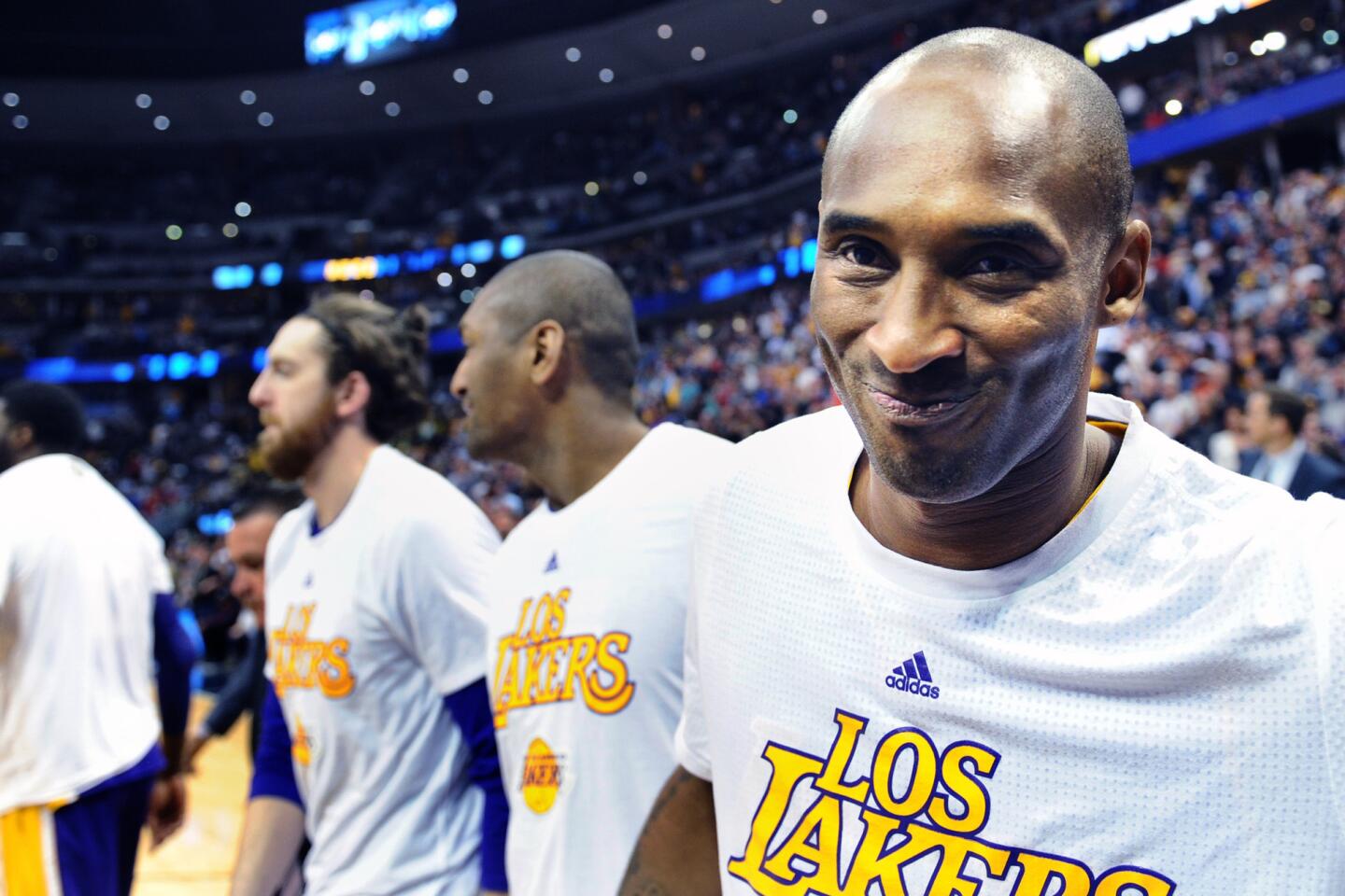 Kobe Bryant smiles as he leaves the courtafter his final game in Denver on March 2, 2016.