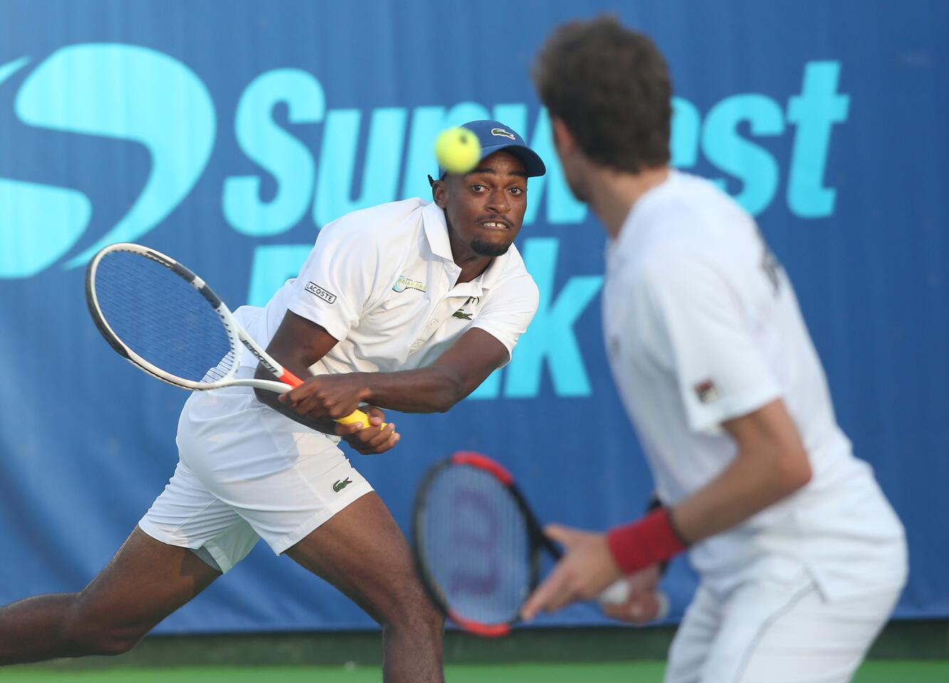 Orange County Breakers player Darian King runs down a backhand at the baseline as partner Marcelo Demoliner looks on during WTT men's doubles match against the Springfield Lasers on Wednesday at Palisades Tennis Club.