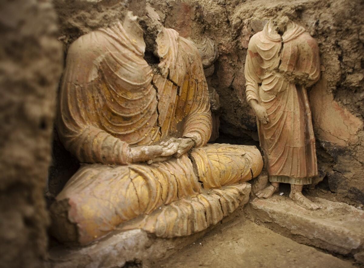 An ancient Buddha statue sits inside a temple at Mes Aynak, south of Kabul, Afghanistan. The site is slated to be turned into a copper mine by China Metallurgical Group Corp.