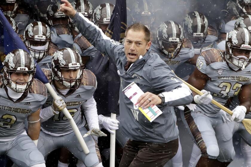 Western Michigan Coach P.J. Fleck leads his team onto the field before a game against Buffalo on Nov. 19.