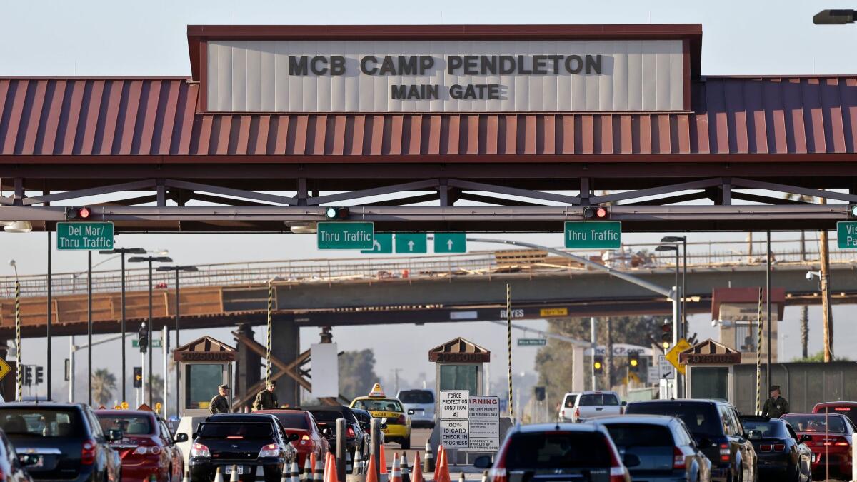 Cars wait to enter Camp Pendleton, where a brush fire has sent a smoky smell wafting over Orange County, officials say.