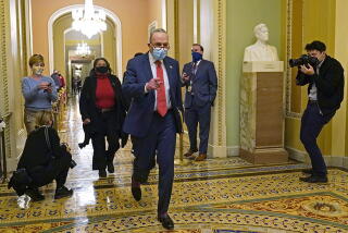 Senate Minority Leader Sen. Chuck Schumer (D- N.Y.) walks past reporters on Capitol Hill in Washington.