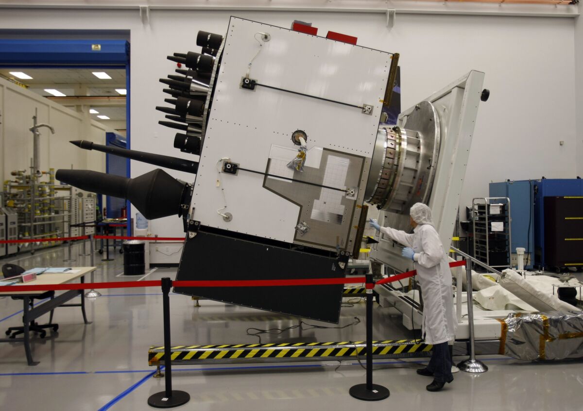 A technician inspects a GPSIIF satellite being built at Boeing's El Segundo facility in 2010.