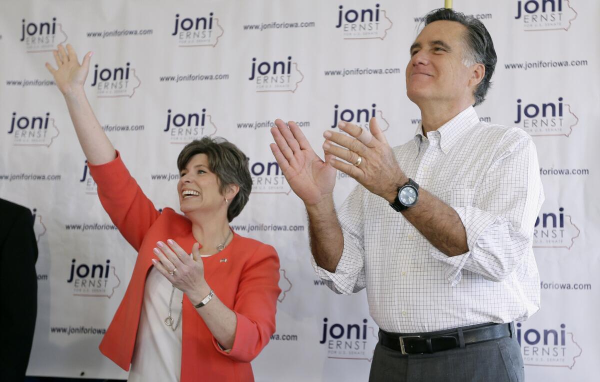 Former Republican presidential nominee Mitt Romney greets supporters before speaking at a rally for Iowa Republican Senate candidate Joni Ernst, left, last month in Cedar Rapids.