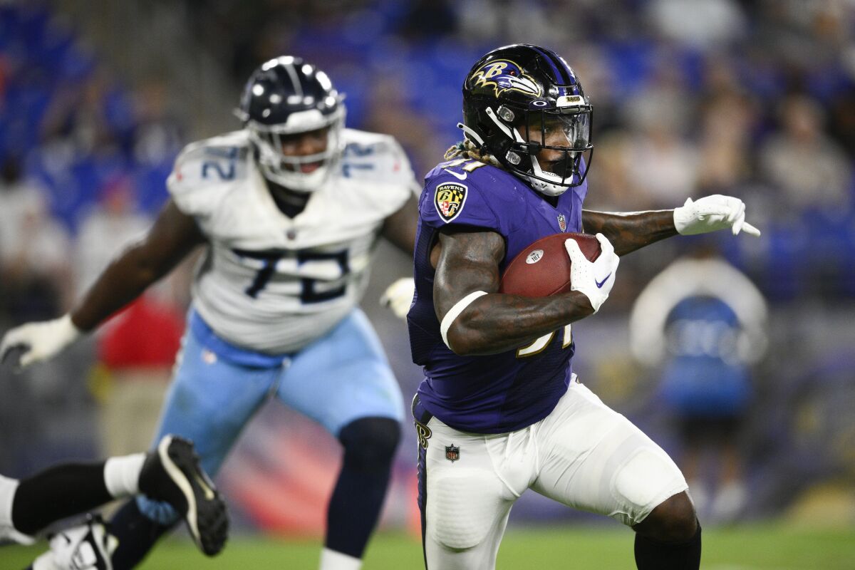 Baltimore Ravens running back Corey Clement runs with the ball against the Tennessee Titans during the second half of a preseason NFL football game, Thursday, Aug. 11, 2022, in Baltimore. (AP Photo/Nick Wass)